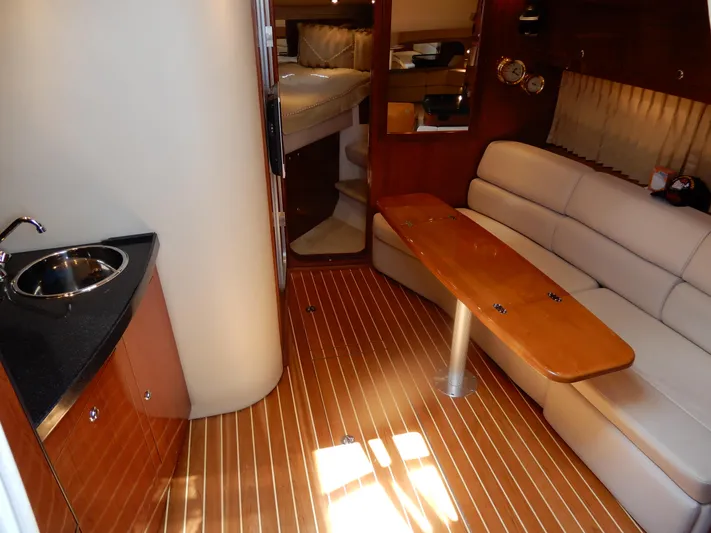  Yacht Photos Pics 2006 Regal Commodore 3760 IO yacht interior with wood flooring, kitchenette, and seating area.