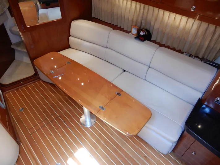  Yacht Photos Pics Luxurious interior of 2006 Regal Commodore 3760 IO yacht with plush seating and wooden table.