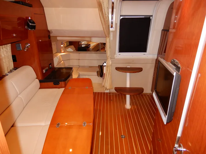  Yacht Photos Pics Luxurious interior of 2006 Regal Commodore 3760 IO yacht with wood finishes and seating.