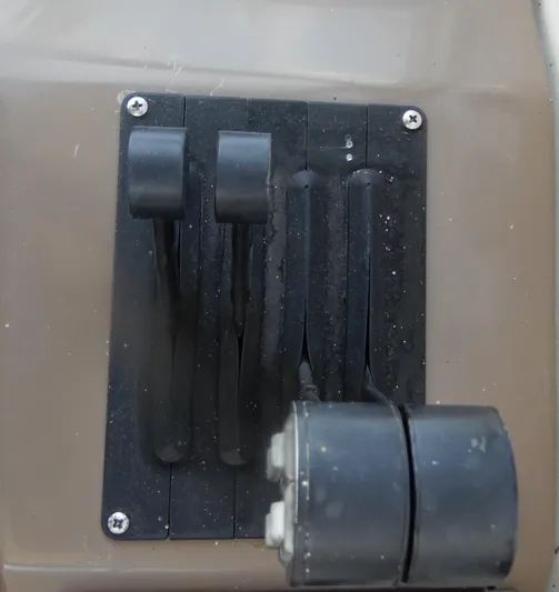  Yacht Photos Pics Control panel of a 2006 Regal Commodore 3760 IO boat with levers and switches.