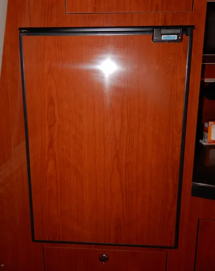  Yacht Photos Pics Wood-paneled refrigerator door in 2006 Regal Commodore 3760 IO yacht interior.