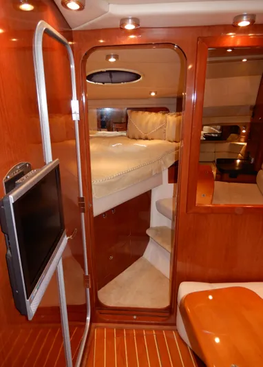  Yacht Photos Pics Luxurious interior of 2006 Regal Commodore 3760 IO yacht with cozy bedroom and TV.