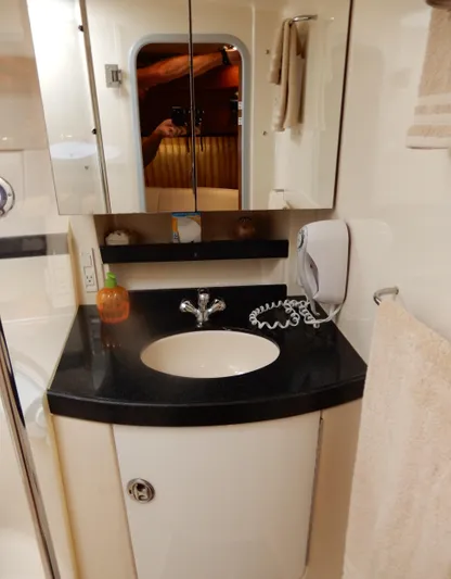  Yacht Photos Pics 2006 Regal Commodore 3760 IO bathroom with sink, mirror, and towel.