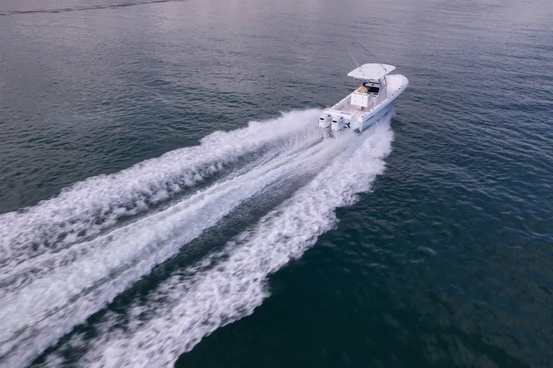  Yacht Photos Pics 2024 Bluewater 2550 boat cruising on open water, leaving a wake behind.