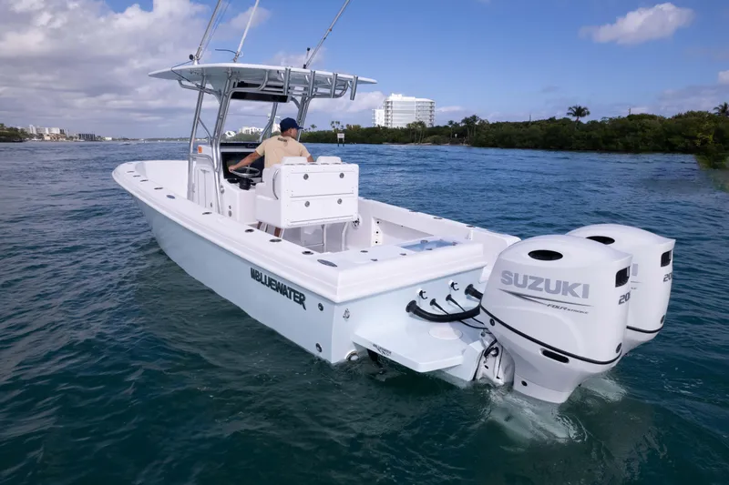  Yacht Photos Pics 2024 Bluewater 2550 boat with dual Suzuki engines cruising on a sunny day.