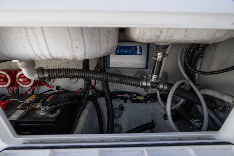  Yacht Photos Pics 2024 Bluewater 2550 boat interior showing battery, wiring, and plumbing components.