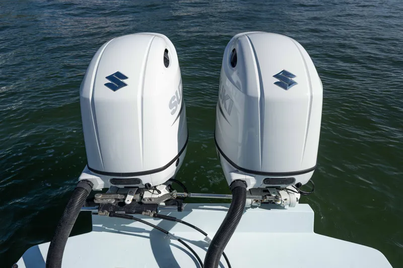  Yacht Photos Pics Twin Suzuki outboard motors on a 2024 Bluewater 2550 boat in water.