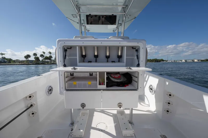  Yacht Photos Pics 2024 Bluewater 2550 boat with open storage compartments on a sunny day.