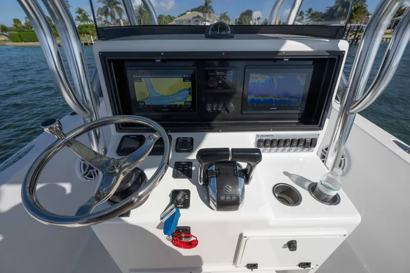  Yacht Photos Pics 2024 Bluewater 2550 boat console with steering wheel, navigation screens, and controls.
