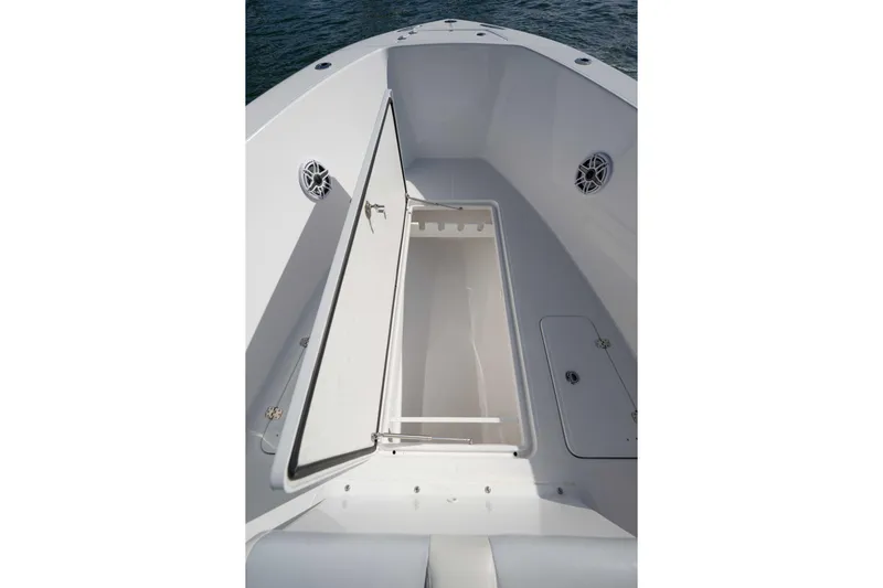 Yacht Photos Pics 2024 Bluewater 2550 boat interior with open storage compartment and speakers.