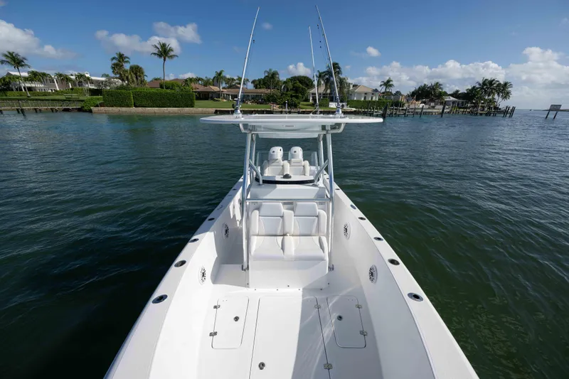  Yacht Photos Pics 2024 Bluewater 2550 boat on calm water, showcasing sleek design and spacious deck.
