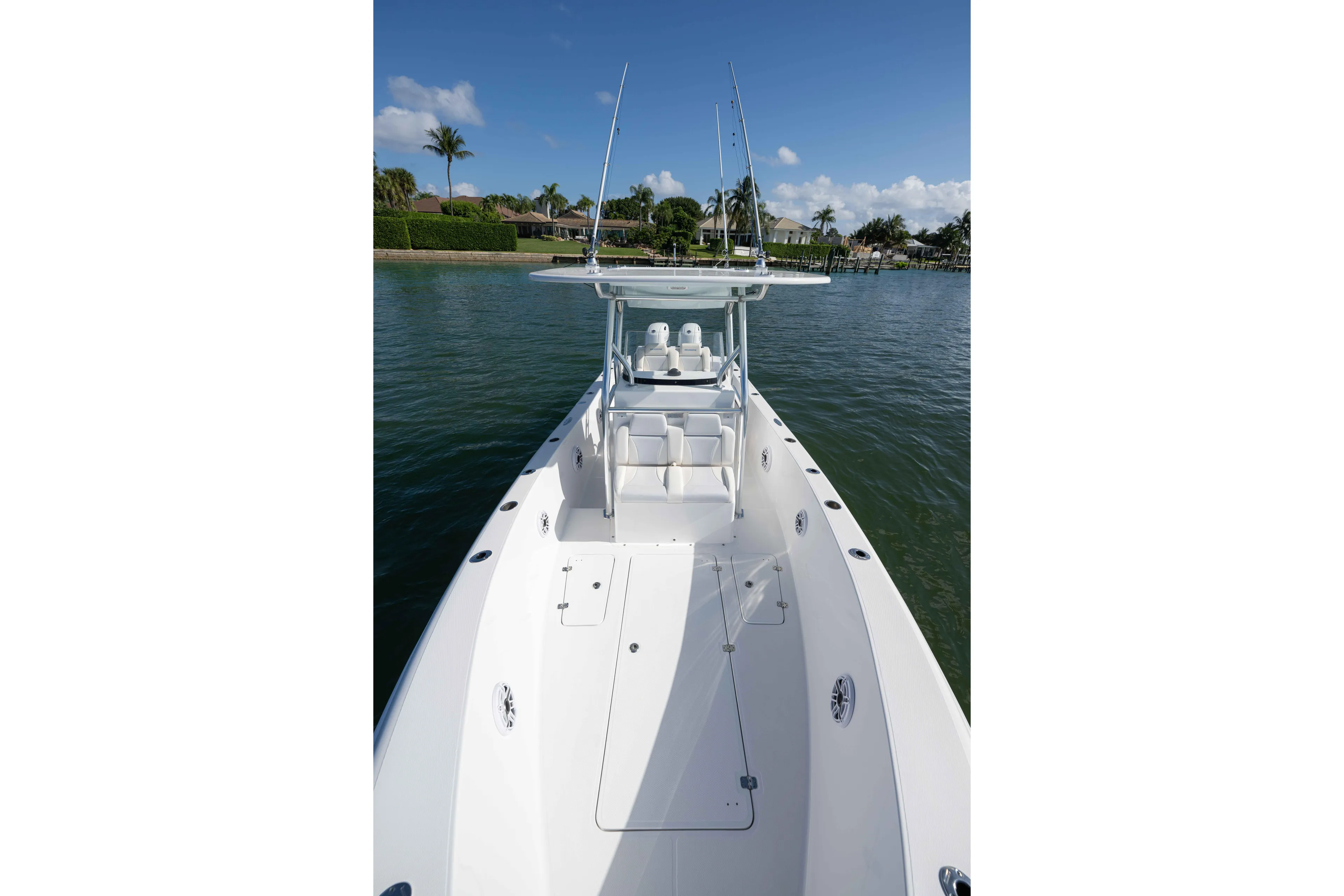  Yacht Photos Pics 2024 Bluewater 2550 boat on calm water, showcasing sleek design and spacious deck.