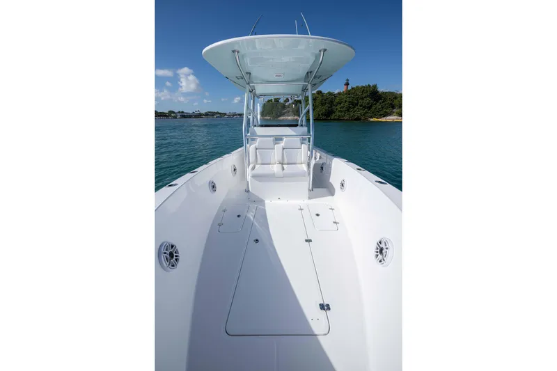  Yacht Photos Pics 2024 Bluewater 2550 boat on calm water, featuring spacious deck and sleek design.