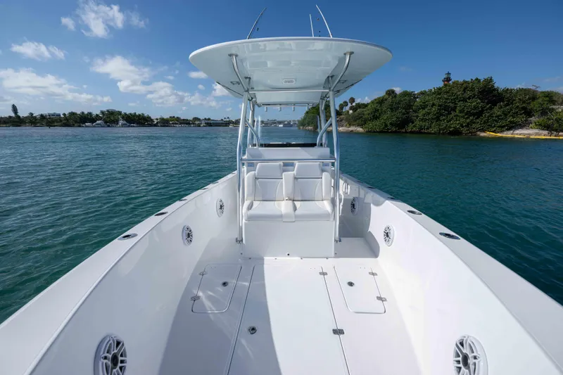  Yacht Photos Pics 2024 Bluewater 2550 boat on calm water, featuring spacious deck and sleek design.