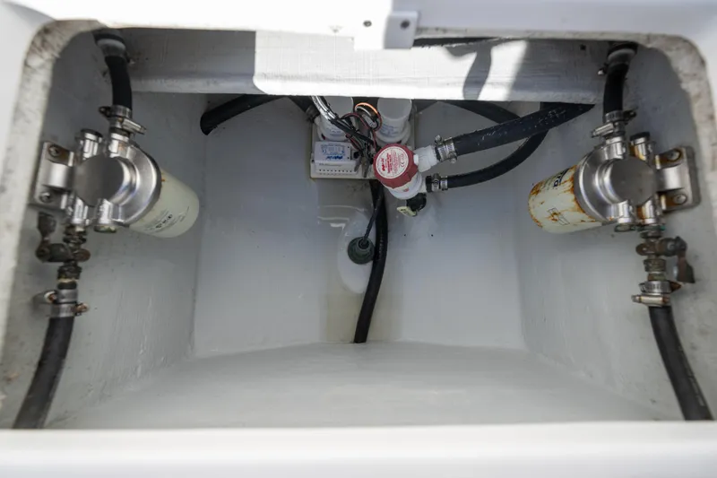  Yacht Photos Pics 2024 Bluewater 2550 boat compartment with fuel filters and hoses.