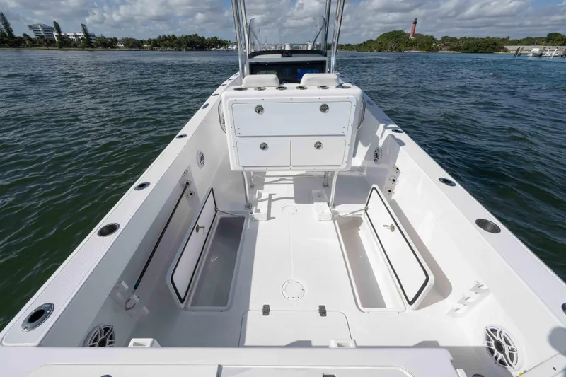  Yacht Photos Pics 2024 Bluewater 2550 boat interior with open storage compartments on calm water.