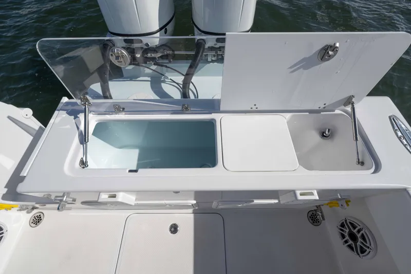  Yacht Photos Pics 2024 Bluewater 2550 boat with open storage compartments and sink on deck.