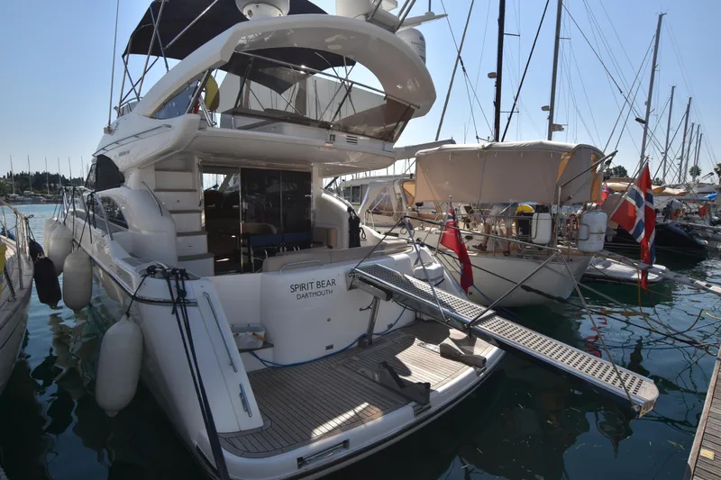 Spirit Bear Yacht Photos Pics Luxury yacht Princess 50, 2006 model, docked in a marina with surrounding boats.