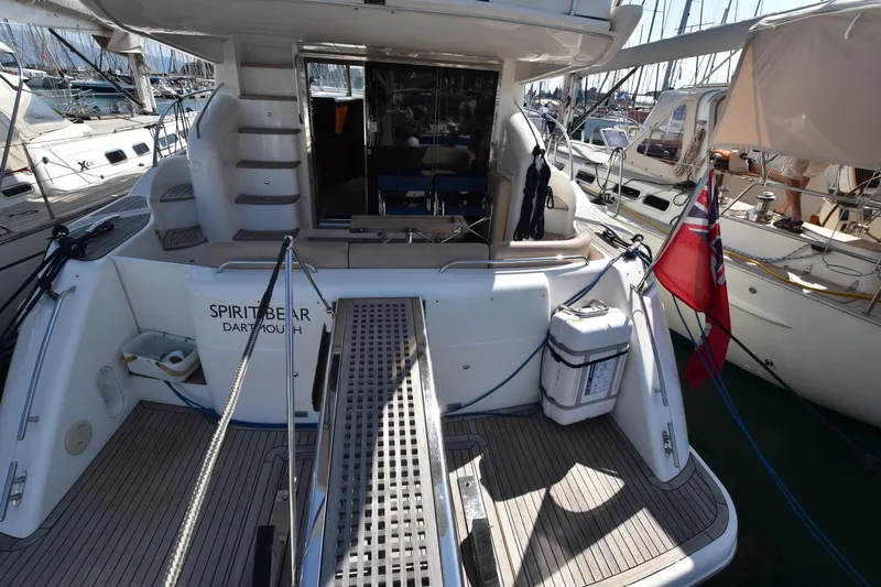 Spirit Bear Yacht Photos Pics Luxury yacht Princess 50, 2006 model, docked with visible boarding ramp and flag.