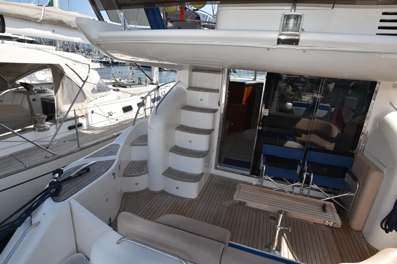 Spirit Bear Yacht Photos Pics Luxurious 2006 Princess 50 yacht interior with seating, table, and stairs.