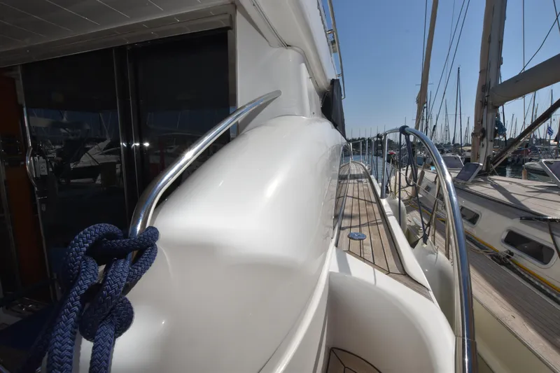 Spirit Bear Yacht Photos Pics Side view of a 2006 Princess 50 yacht docked at a marina.