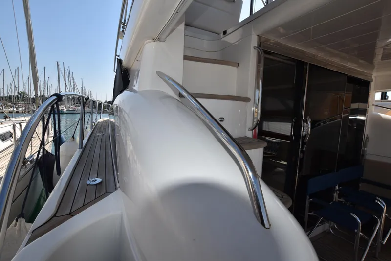 Spirit Bear Yacht Photos Pics Side deck view of 2006 Princess 50 yacht with sleek design and wooden flooring.