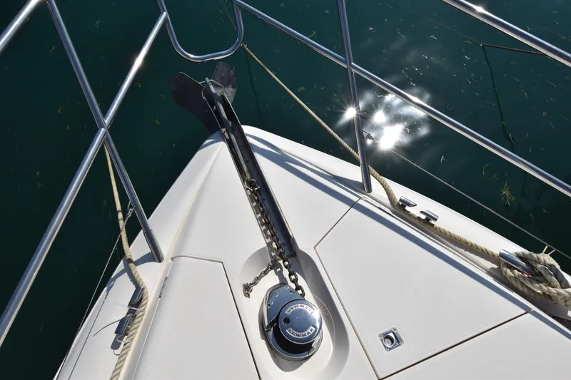 Spirit Bear Yacht Photos Pics Bow of 2006 Princess 50 yacht with anchor and railing, reflecting sunlight on water.