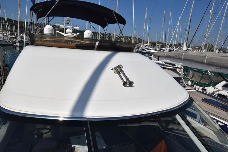 Spirit Bear Yacht Photos Pics Luxury Princess 50 yacht from 2006 docked in a marina, surrounded by sailboats.