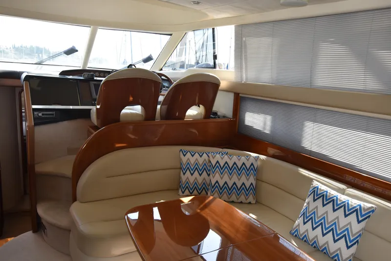 Spirit Bear Yacht Photos Pics Luxurious interior of a 2006 Princess 50 yacht with elegant seating and helm.