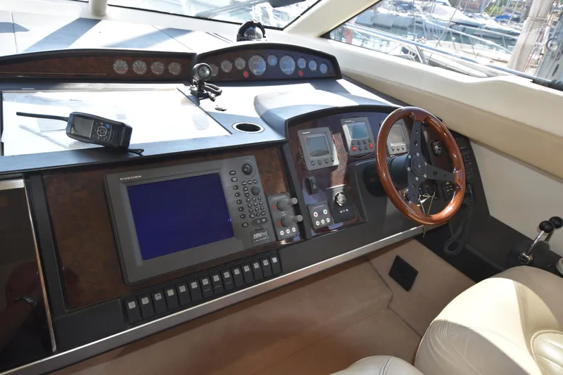 Spirit Bear Yacht Photos Pics Helm of 2006 Princess 50 yacht with navigation equipment and wooden steering wheel.