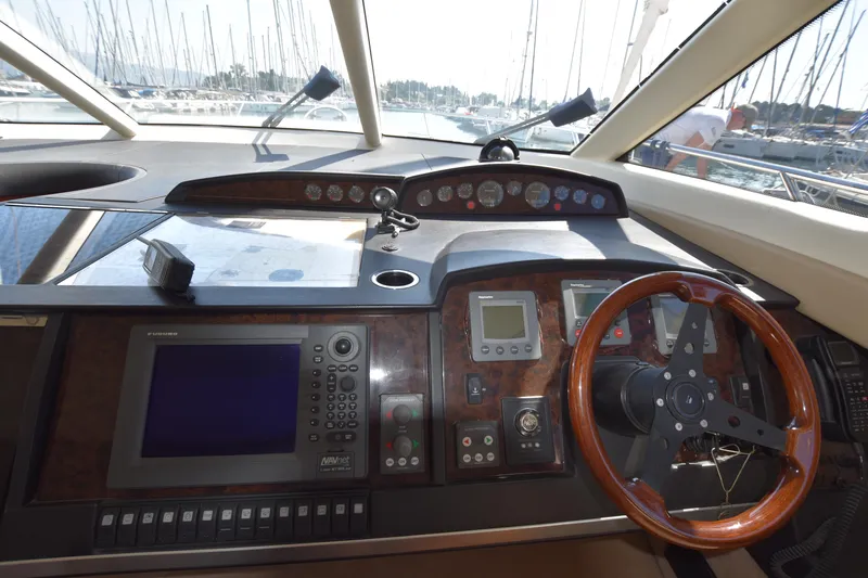 Spirit Bear Yacht Photos Pics Helm of 2006 Princess 50 yacht with navigation instruments and wooden steering wheel.
