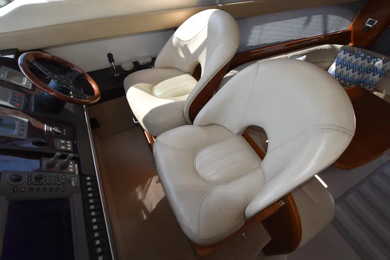 Spirit Bear Yacht Photos Pics Luxurious interior of 2006 Princess 50 yacht with plush white seating and control panel.