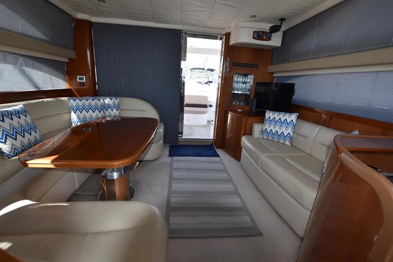 Spirit Bear Yacht Photos Pics Luxurious interior of a 2006 Princess 50 yacht with elegant seating and wooden finishes.