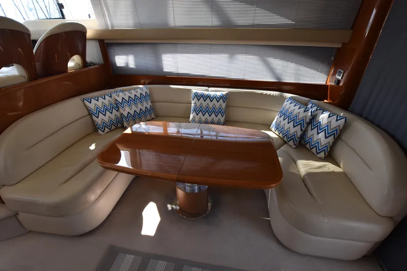 Spirit Bear Yacht Photos Pics Luxurious interior of a 2006 Princess 50 yacht with plush seating and chevron pillows.