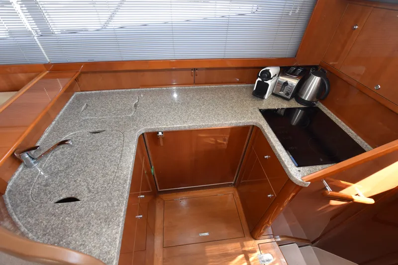 Spirit Bear Yacht Photos Pics Luxurious kitchen area in a 2006 Princess 50 yacht with modern appliances and sleek countertops.