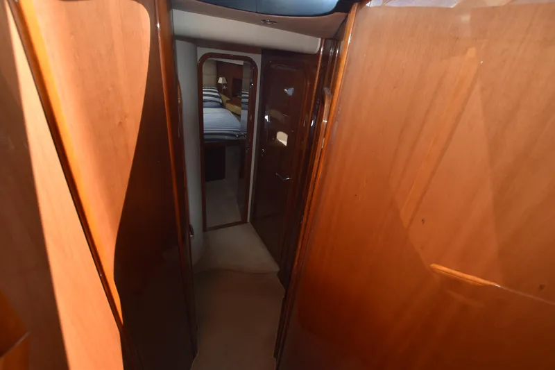 Spirit Bear Yacht Photos Pics Interior hallway of 2006 Princess 50 yacht with wooden paneling and bedroom view.