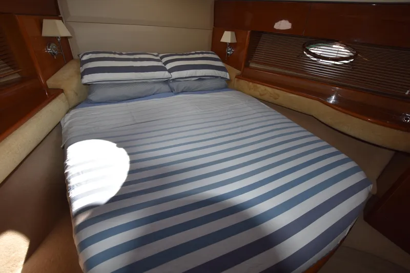 Spirit Bear Yacht Photos Pics Luxurious cabin interior of 2006 Princess 50 yacht with striped bedding.