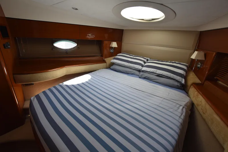 Spirit Bear Yacht Photos Pics Luxurious cabin interior of 2006 Princess 50 yacht with striped bedding.