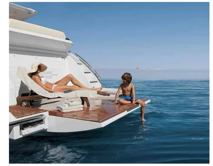  Yacht Photos Pics Azimut 55S yacht, 2012 model, with people relaxing on the deck by the sea.