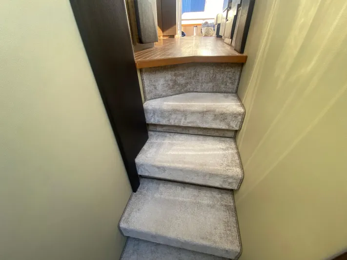  Yacht Photos Pics Staircase inside 2012 Azimut 55S yacht with carpeted steps and wooden accents.
