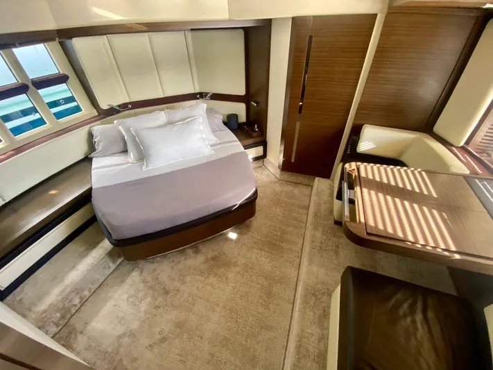  Yacht Photos Pics Luxurious interior of 2012 Azimut 55S yacht featuring a cozy bedroom and elegant furnishings.