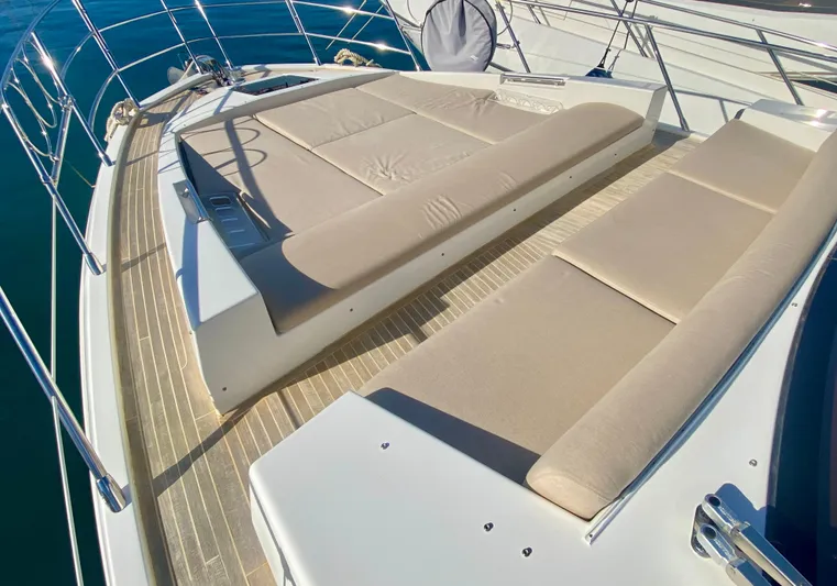  Yacht Photos Pics Luxurious sunbathing area on 2012 Azimut 55S yacht with cushioned loungers.