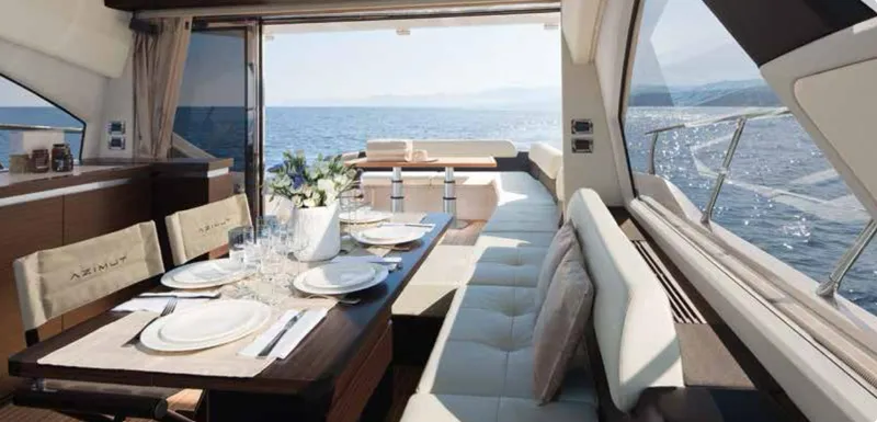  Yacht Photos Pics Luxurious interior of 2012 Azimut 55S yacht with elegant dining setup and ocean view.