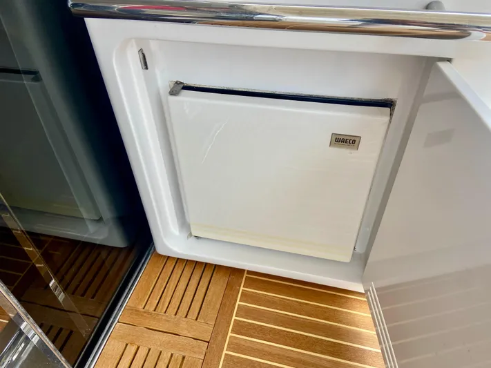  Yacht Photos Pics Azimut 55S 2012 yacht interior with a built-in fridge and wooden flooring.