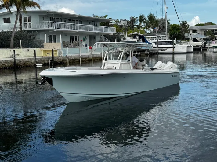  Yacht Photos Pics 2022 Sailfish 290 CC boat docked near waterfront homes and yachts.