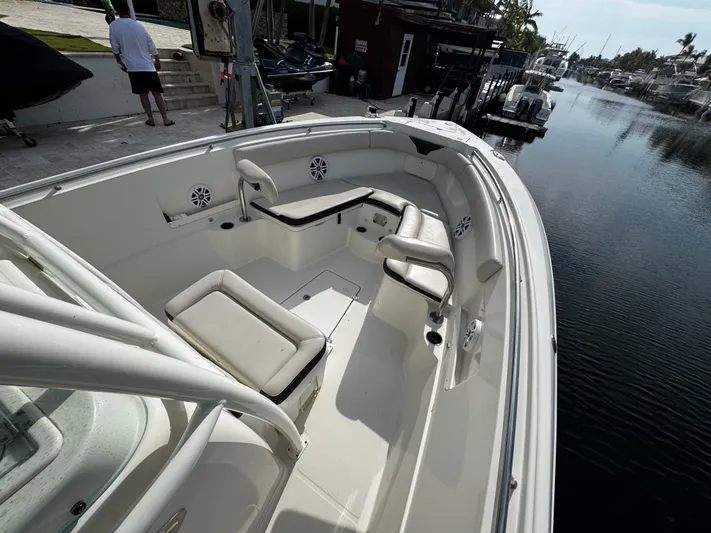  Yacht Photos Pics 2022 Sailfish 290 CC boat interior with seating, docked by a canal.