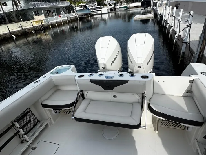  Yacht Photos Pics 2022 Sailfish 290 CC boat with triple outboard engines docked in a marina.