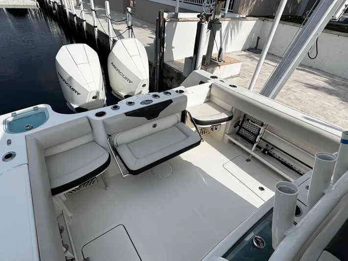  Yacht Photos Pics 2022 Sailfish 290 CC boat interior with seating and twin outboard engines.