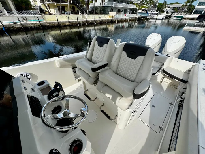  Yacht Photos Pics 2022 Sailfish 290 CC boat interior with dual captain's chairs and steering wheel.