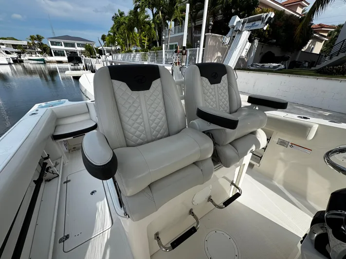  Yacht Photos Pics Luxury seating on 2022 Sailfish 290 CC boat, docked in a serene marina.